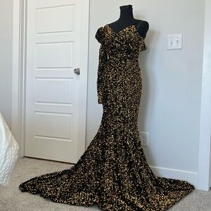 Gold black sequin gown,  formal occasion has long sleeve right arm.